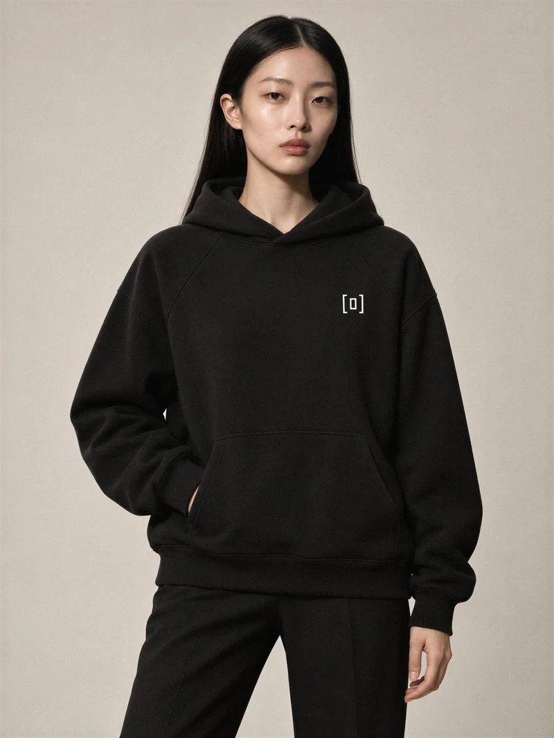 Sakura wears a black super-heavyweight hoodie with the small white on display. frame logo embroidered on her left chest.